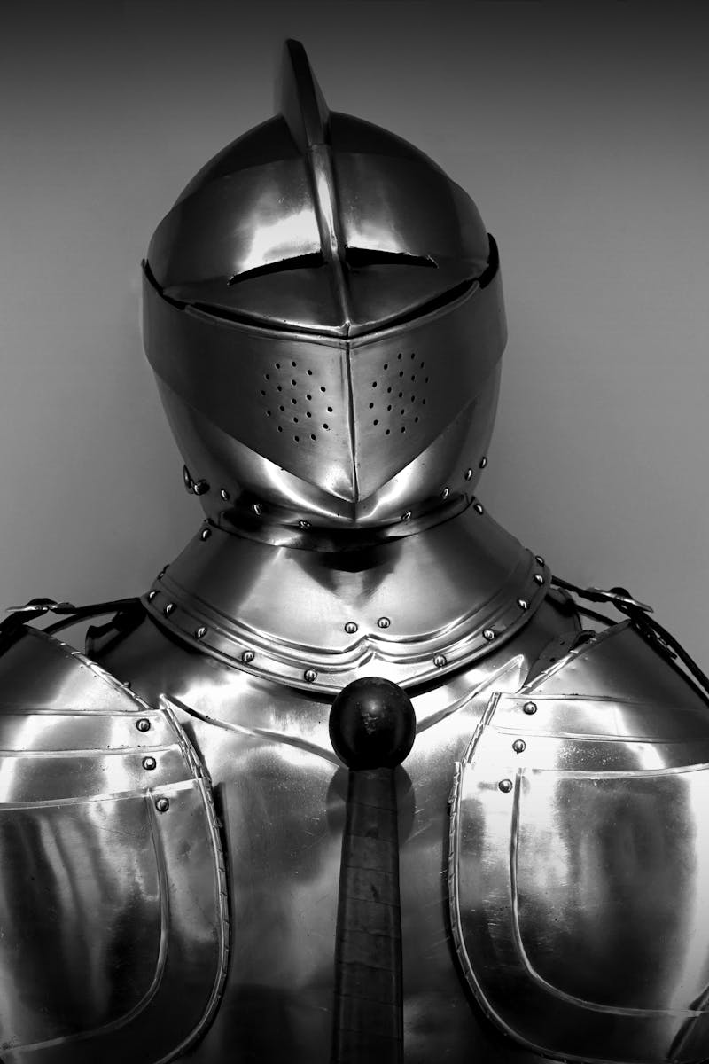 Close-up shot of vintage medieval knight armor in monochrome.